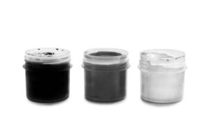 Three jars of silver and black conductive inks used in printed electronics for creating circuits and functional components.