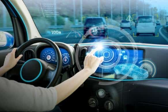 Futuristic car dashboard with a printed touch interface, illustrating automotive applications of flexible and capacitive electronics.